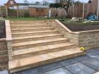 Retaining wall behind fascia walling,